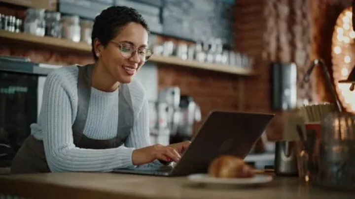 Woman on a laptop in a coffee shop.